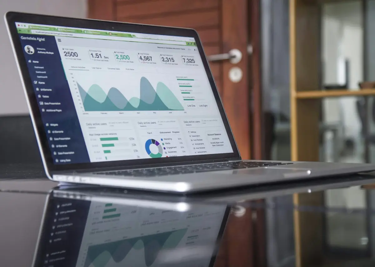 Laptop displaying an analytics dashboard with charts and graphs.